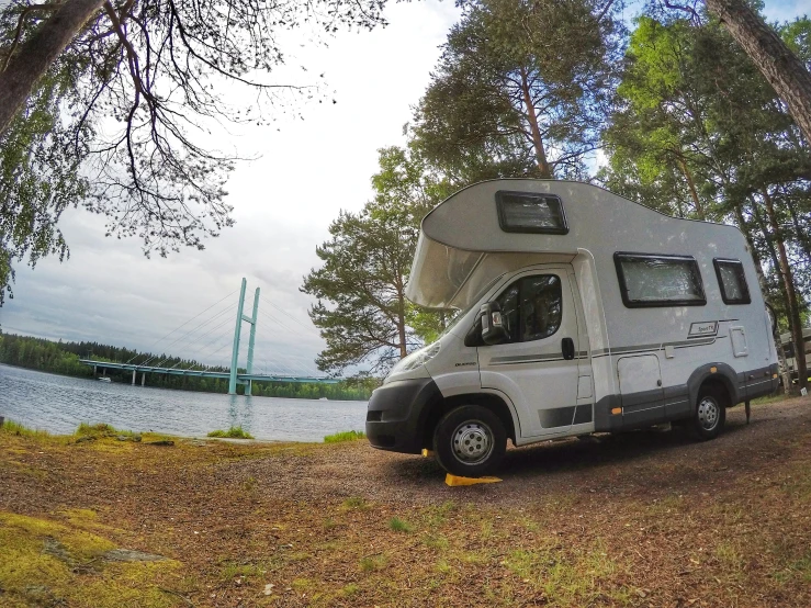 a small camper on the shore of a lake