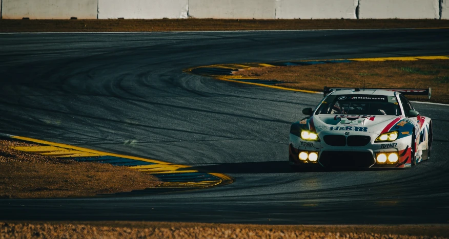 a bmw race car driving around a turn