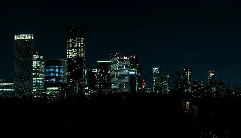 a night scene with buildings and lights lit up