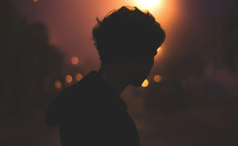 the silhouette of a person in the dark