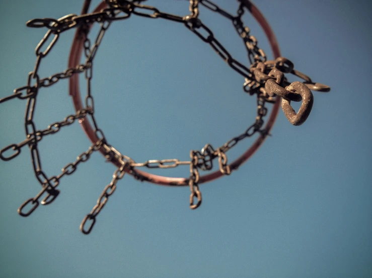 a metal chain hanging from a sky filled with lots of links