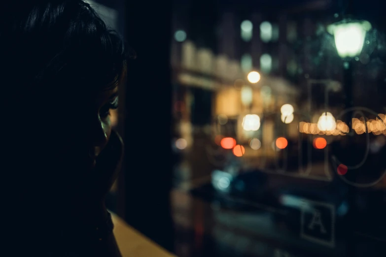 the silhouette of a woman talking on her cell phone