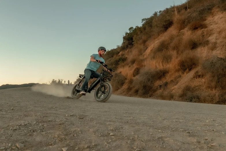 a man riding a bike through a desert