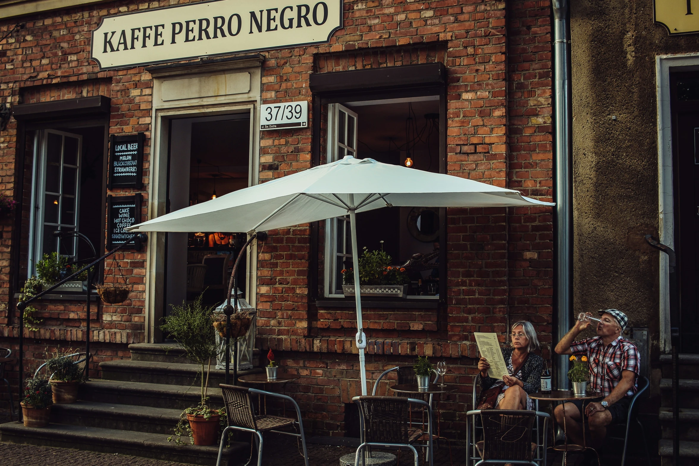 the woman is sitting outside in her restaurant