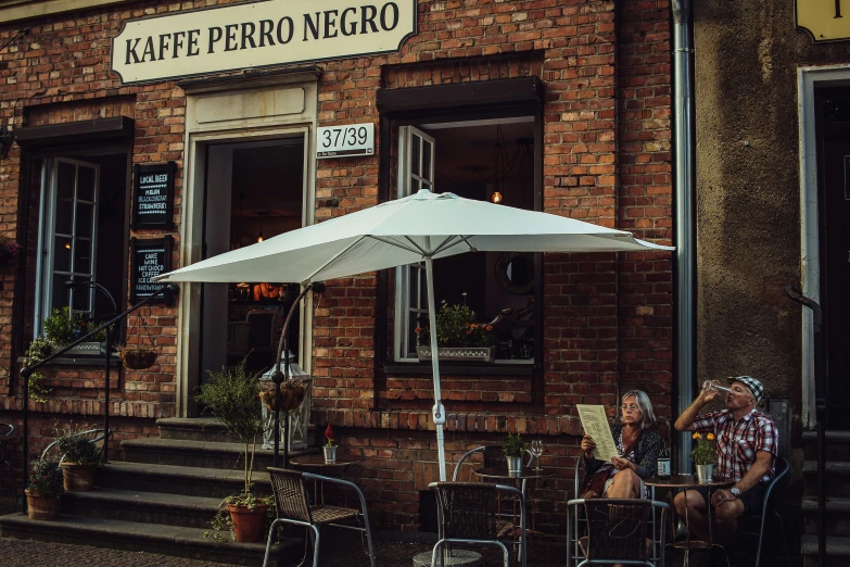 the woman is sitting outside in her restaurant