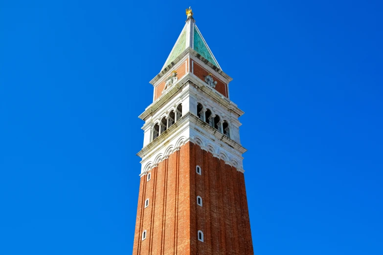 a large clock tower with a blue sky in the background