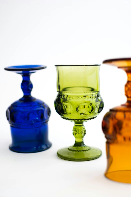 four small colorful vases sit side by side