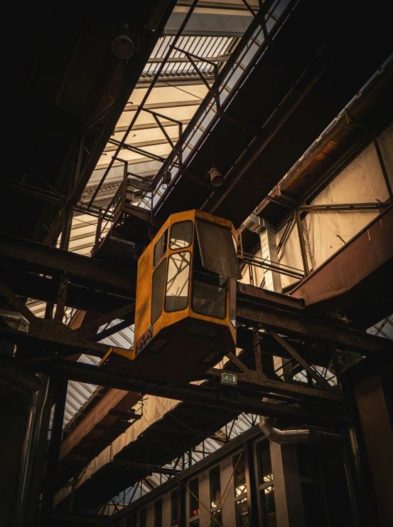 a train with a clock on the roof, under a large building