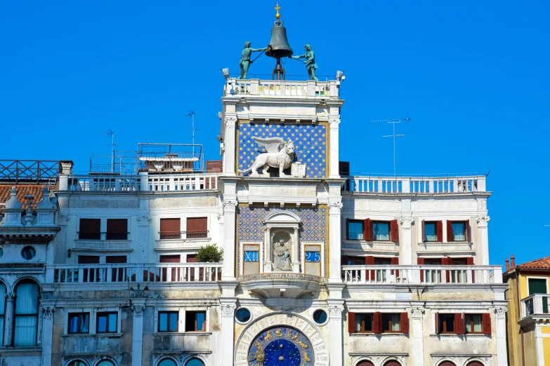an intricate building with a blue door and a clock on top