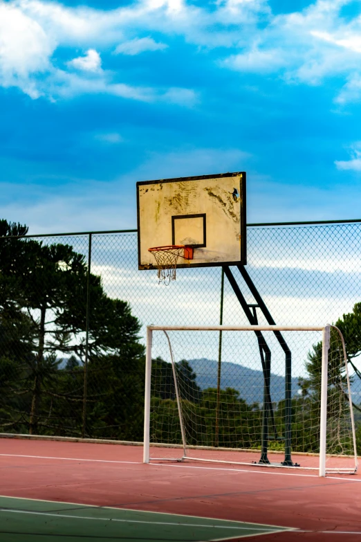 an empty basketball court with a net and ball on it