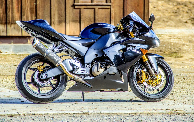 the motorbike is parked by the wooden door