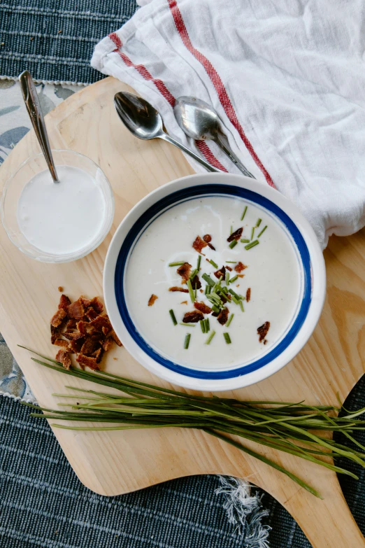 the bowl is filled with yogurt and chopped vegetables