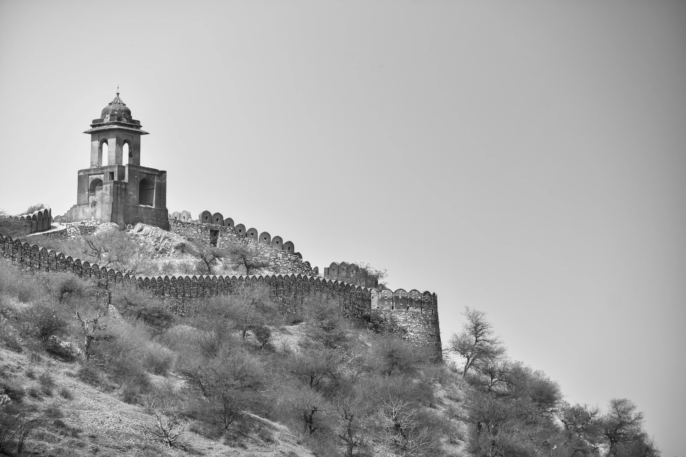 a black and white po of a castle on top of a mountain