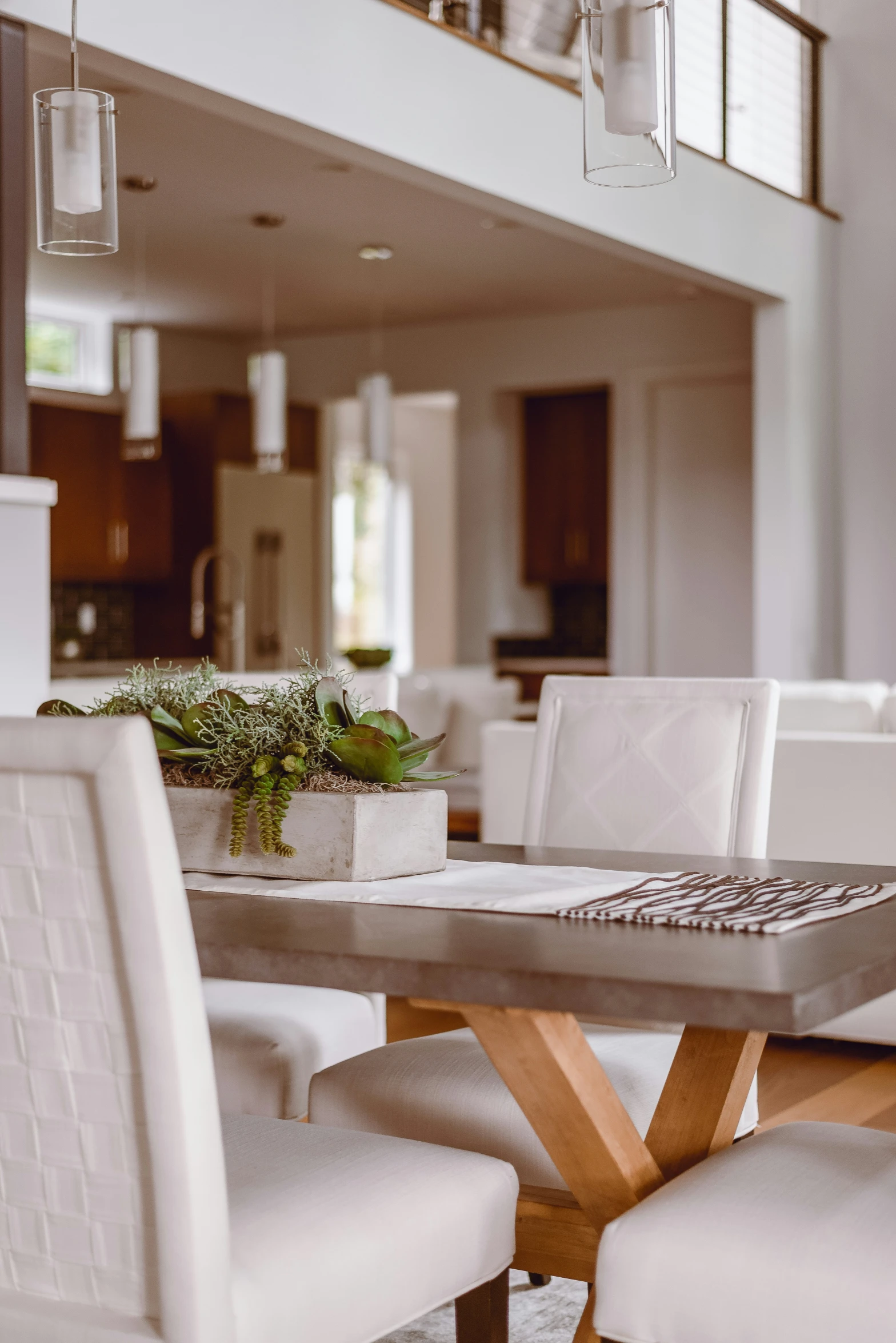 an elegant white dining room with wood chairs