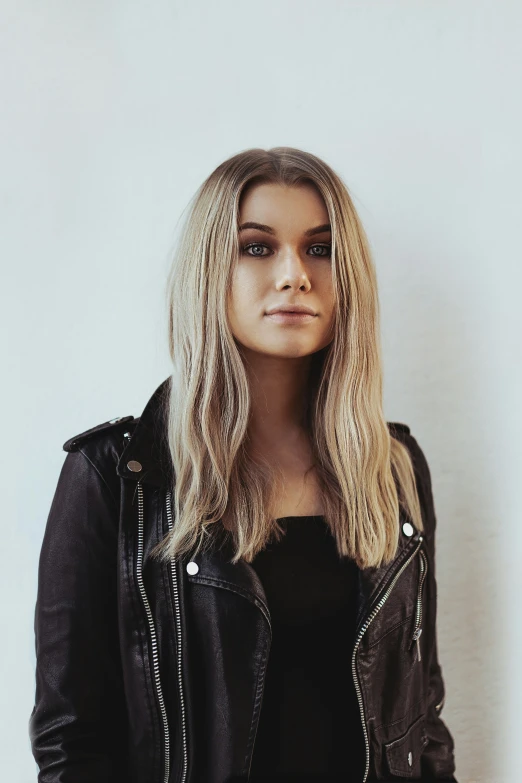 a woman wearing black leather jacket with short hair