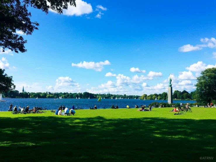 an image of people on grass and in water