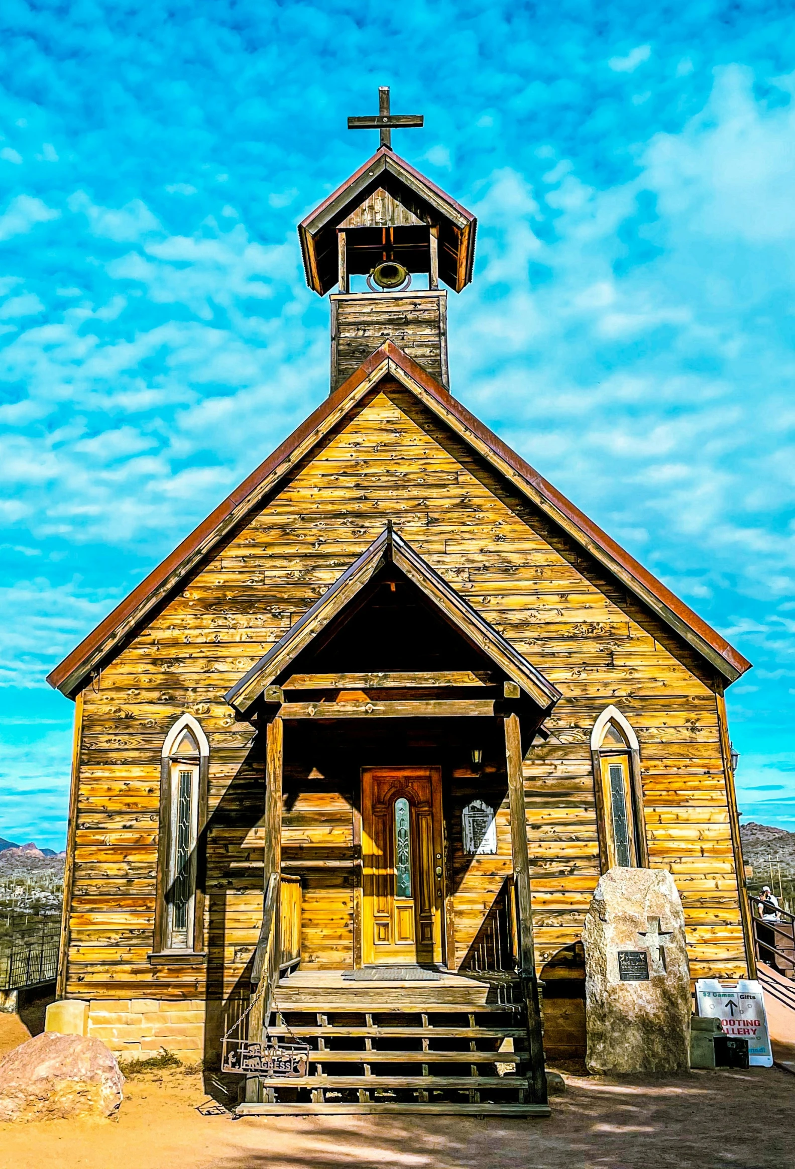 an old church with a steeple and cross on the top