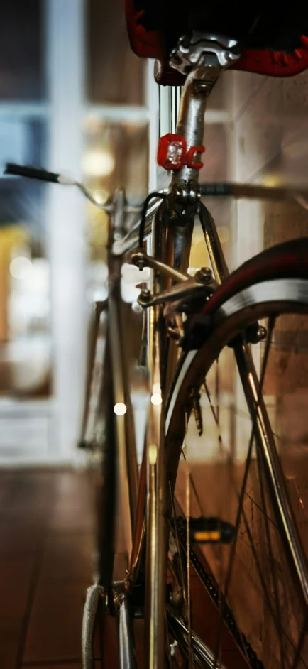 the bicycle is locked to the wall for storage