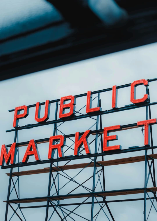 a red and black sign is on top of a building