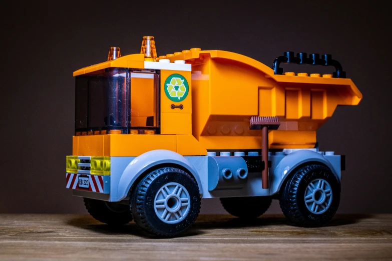 a toy truck on a wooden table with brown background