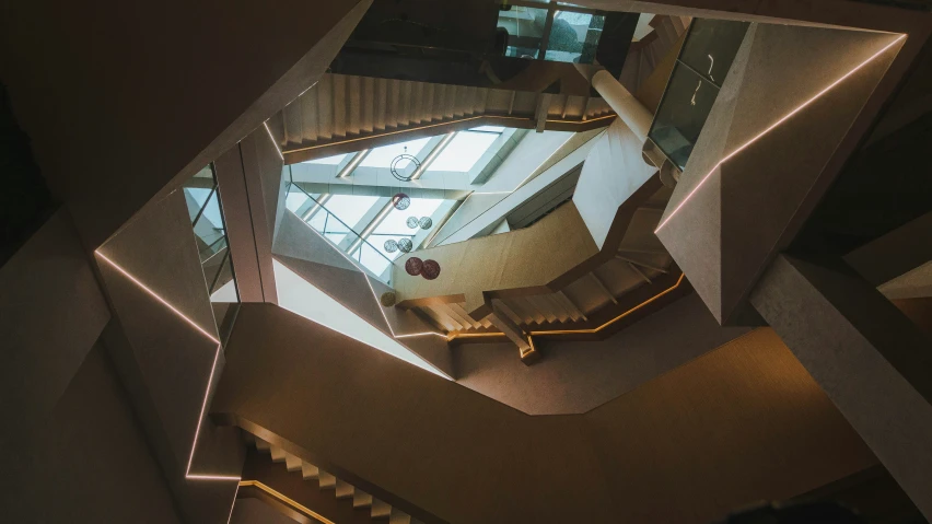 a spiral stair case made from mirrors in a building