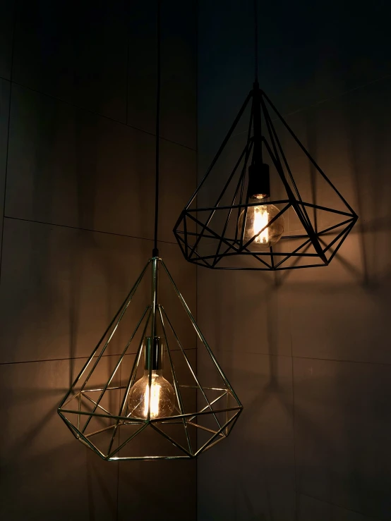 two hanging lights that have lights inside of them