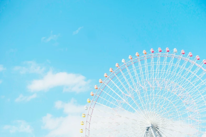 an amut park ferris wheel on a blue sky day