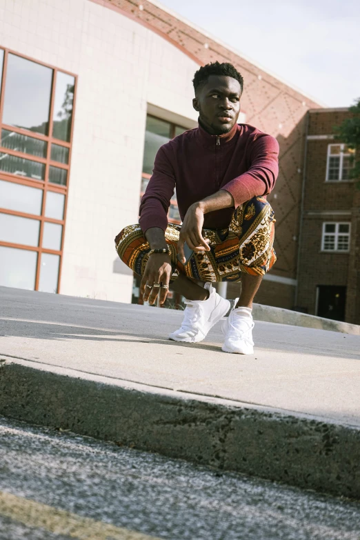 a person sitting on a concrete ledge with a skateboard