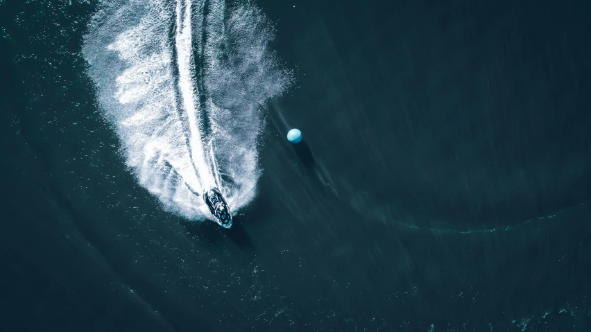 the water behind a boat has two people on it