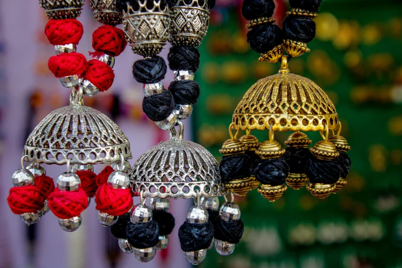 colorful beads hang from hooks in the middle of a shop