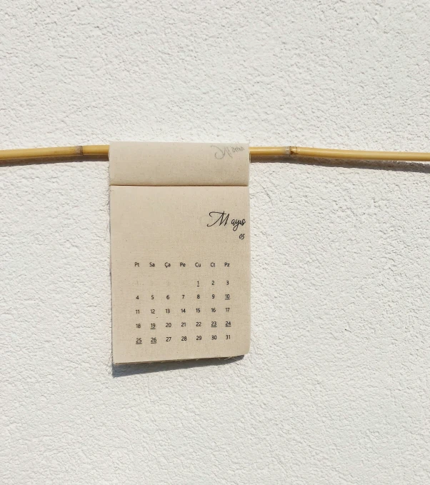 an old calendar hanging on a clothes line