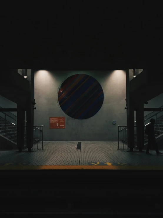 a person walks under an awning at a station platform