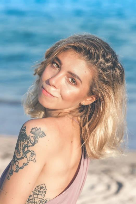 a close - up of a girl with a long id in front of the ocean