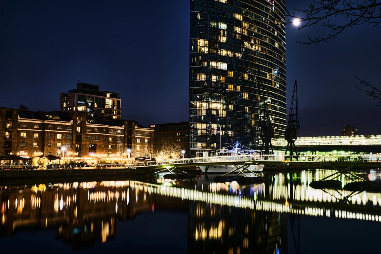 a dark skyline sits above a still calm river