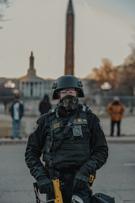 a cop standing in front of a monument while wearing a helmet