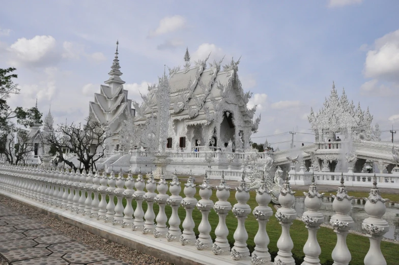 a large white structure that has statues and pillars in front