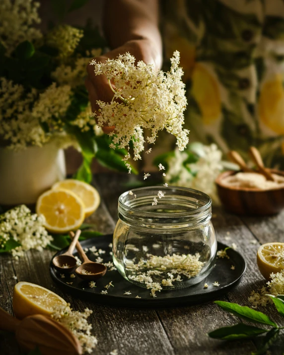 small jar filled with flowers and some other flowers