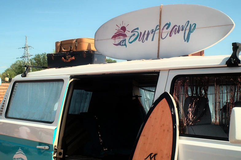 a white van with surf boards attached to the roof