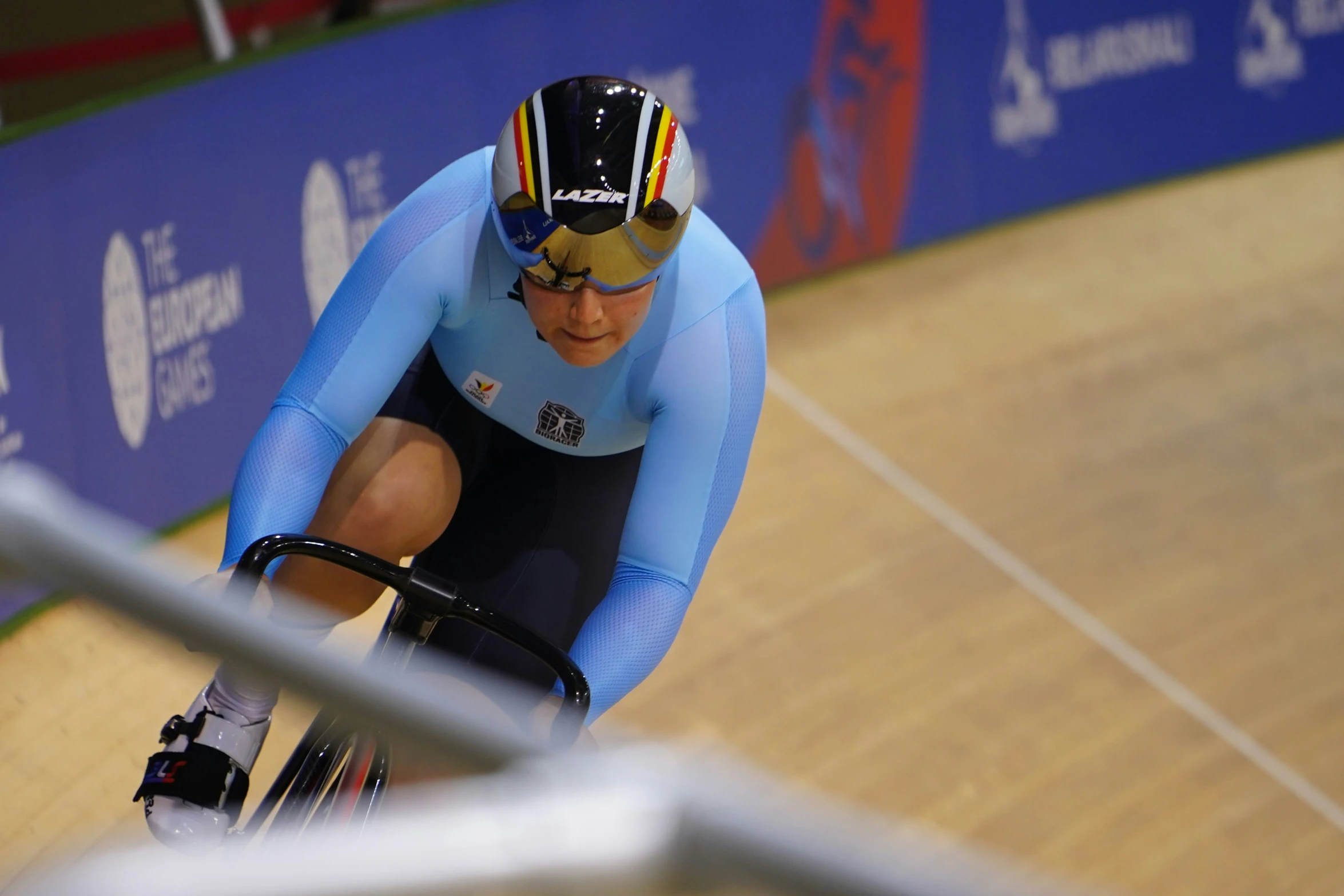 a bicyclist on the race track with a helmet over his face