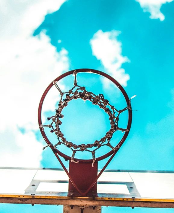 a basketball going through a hoop that has chains on it