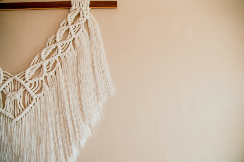 a white macrame hanging on a wall