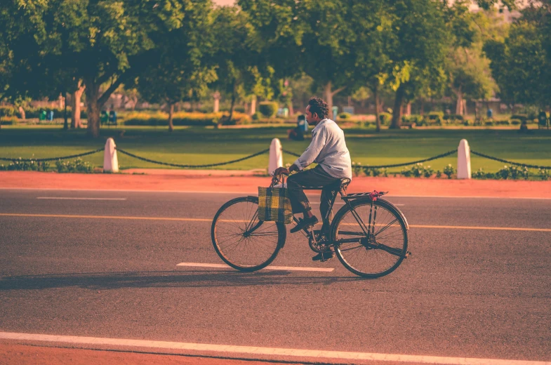 the man is riding his bike down the street