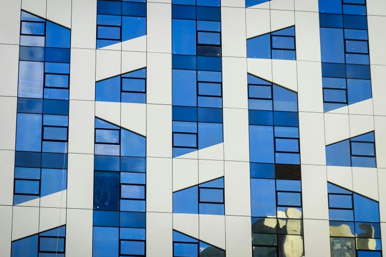 a reflection of a clock in a window next to a building