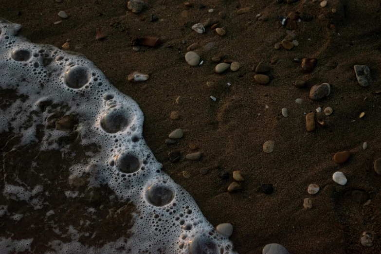 water and rocks on a sandy beach