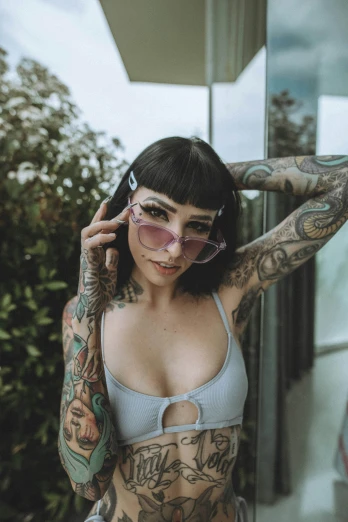 a women in a bikini wearing goggles and tattoos