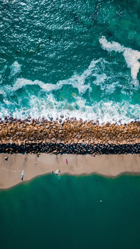 a view from above showing a sandy beach with waves