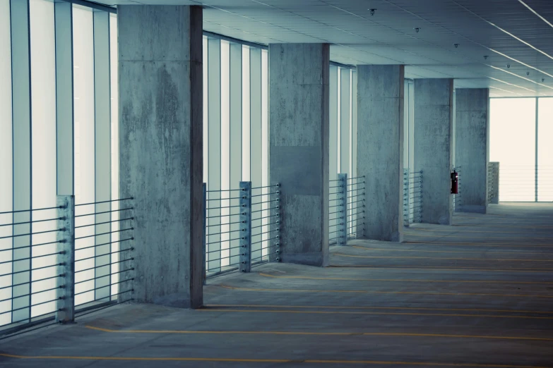 a row of windows in the center of an empty parking garage