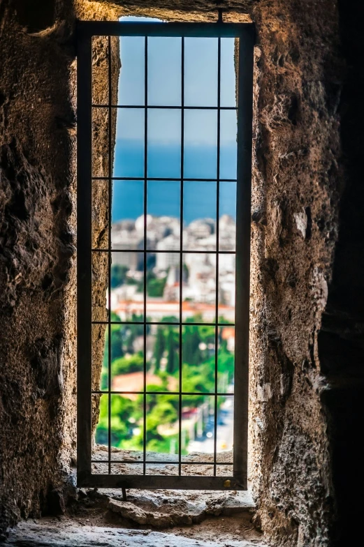 a window with bars on the side of a building