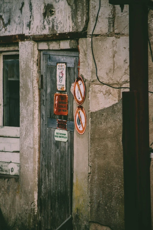 a door is open next to a building with a few signs on it