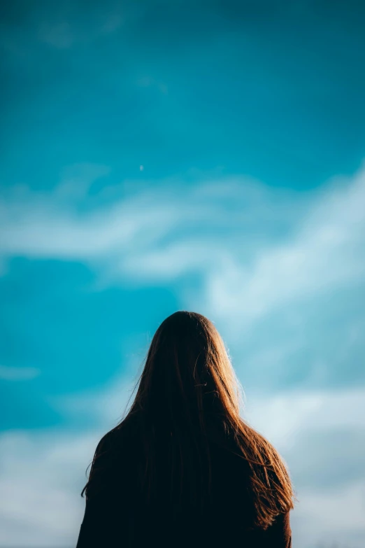 woman's hair is blown out on the beach